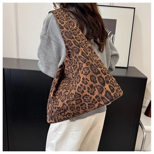 Leopard print tote bag shown on model highlighting the spacious bucket style and soft fabric