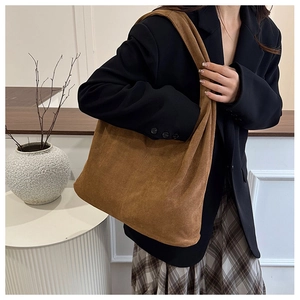 Close-up of brown suede hobo tote bag texture and soft minimalist shoulder design