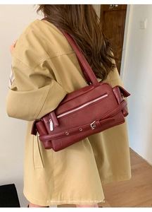 Sophisticated burgundy leather shoulder bag with metallic buckle detail in retro vibe
