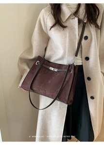 Detail of vintage matte brown tote bag with silver twist lock and minimalist design