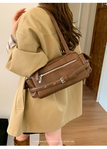 Brown retro shoulder bag styled with a beige trench coat for a minimalist chic vibe