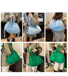 Quilted puffer bag in sky blue and emerald green with drawstring and knot details