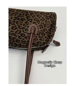 Detail of leopard print suede Boston bag with silver zipper and magnetic buckle closure