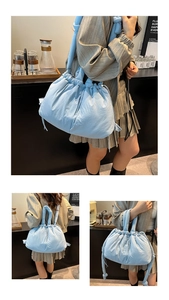Detail view of light blue quilted puffer tote bag with drawstring closure and soft handles