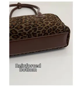 Close-up of leopard print baguette bag featuring a reinforced thick base and white stitching