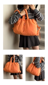 Detail of orange puffer tote bag with drawstring closure and thick padded handles