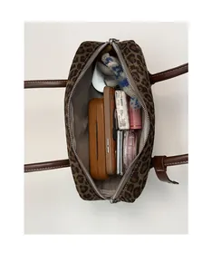 Top view of spacious interior of leopard print boston bag with daily essentials inside