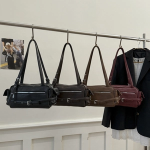 Vintage style shoulder bags in black and brown leather with zippers and buckle details