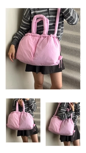 Detail view of pink quilted puffer tote bag featuring soft padding and drawstring closure