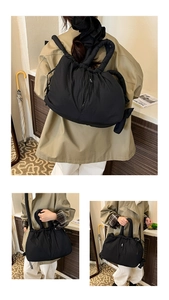 Detail of black quilted puffer tote bag with drawstring closure and large capacity
