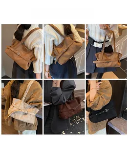 Detail view of retro matte leather tote bag showing adjustable belt and metal buckle hardware