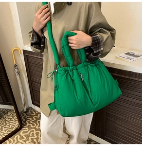 Close-up of bright green puffer tote bag with drawstring closure and quilted nylon texture