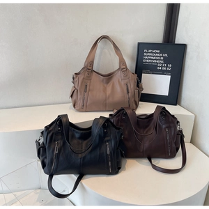 Detailed comparison of large tote bags in black, brown, and khaki textured leather