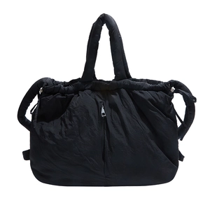 Quilted black nylon tote bag with puffy cloud design and front vertical zipper detail