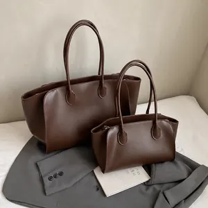 Detailansicht des dunkelbraunen Leder-Tote-Bag-Sets mit Blattförmiger Naht am Tragegriff