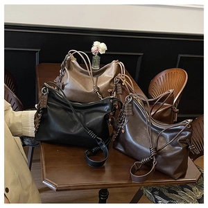 Detailed view of vintage soft leather tote bags with knot straps and chocolate charms