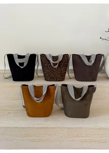 Collection of suede bucket bags with geometric striped straps in five different colors