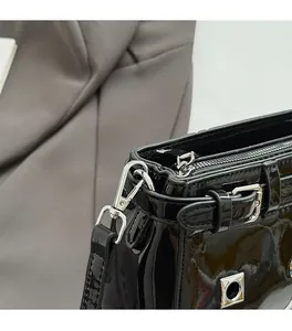 Close-up of premium silver metal buckle and glossy black patent leather strap