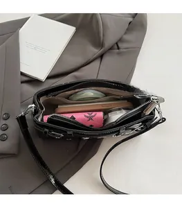 Internal view of the black leather crossbody bag showing large capacity and inner pockets