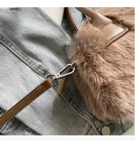 Detailed macro view of plush brown faux fur texture and premium silver metal hardware hooks
