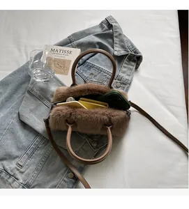Interior view of brown faux fur handbag showing space for phone and cosmetics