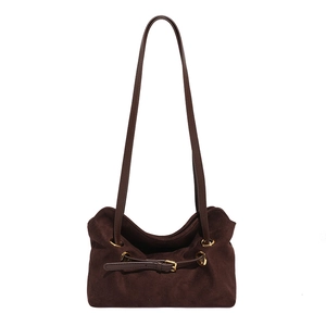 Minimalist deep brown suede crossbody bag with long shoulder straps on white background