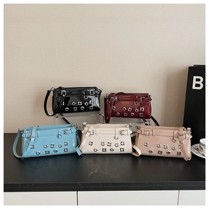 Collection of retro patent leather handbags in five colors with metallic eyelet details