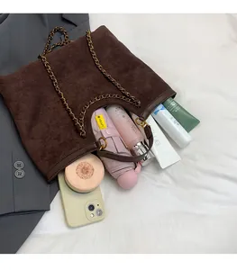Quilted brown suede tote bag with gold chain showing spacious interior for daily items