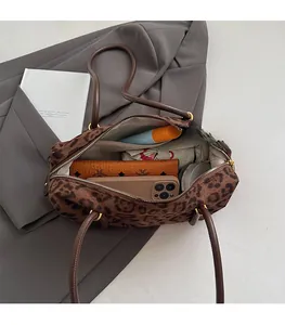 Spacious interior of leopard print tote bag showing daily essentials and large capacity