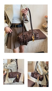 Close-up of leopard print cylindrical bag with brown leather straps and beaded tassel