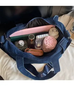 Interior view of large denim tote bag showing spacious capacity for tablets and essentials
