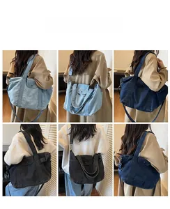 Macro shot of large denim tote bags in various washes with wide shoulder straps