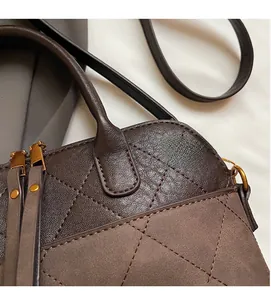 Detailed close-up of retro brown quilted stitching and premium matte leather texture