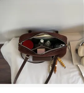 Top view of Boston bag interior showing large storage space for phone and makeup