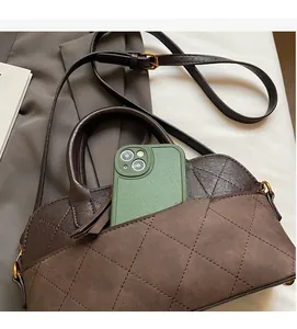 Detail of shell bag interior showing zippered compartment with smartphone for capacity
