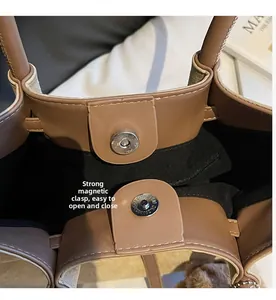 Close-up of secure magnetic snap closure on a vintage leather tote bag interior