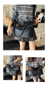 Detail of black large capacity tote with woven shoulder strap and hollow handle