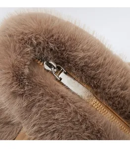 Detail of silver metal zipper pull on premium brown plush faux fur handbag material
