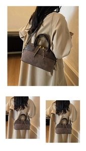 Detailed view of brown quilted crossbody bag with vintage texture and sleek zipper details