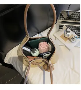 Close-up of large canvas tote bag showing spacious interior with tablet and daily essentials