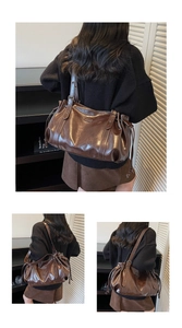 Detail of vintage brown tote bag with leather texture, drawstring and metal buckle