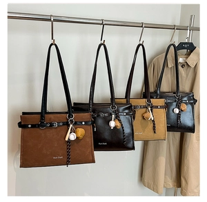 Detailed display of vintage tote bags in four colors with creative sports-themed charms