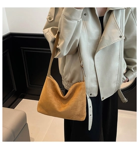 Detail of vintage mustard suede hobo bag showing soft matte texture and draping style