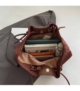 Interior view showing the large capacity of a brown suede tote bag for daily essentials