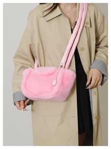 Pink faux fur handbag with fluffy plush texture shown styled with a khaki trench coat