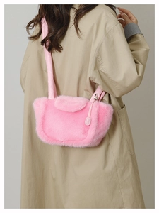 Detailed close-up of fluffy pink faux fur shoulder bag worn with a khaki trench coat