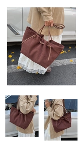 Detail of dark brown suede tote bag with decorative drawstrings in an autumn street setting