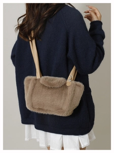 Detailed back view of a plush faux fur tote bag with long smooth shoulder straps in brown