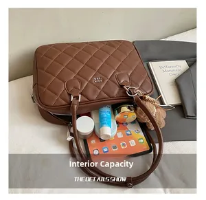 Internal capacity of brown quilted handbag showing tablet and cosmetics storage space