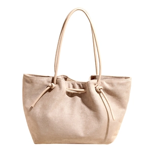 Minimalist beige suede tote bag with drawstring closure and knotted side detail